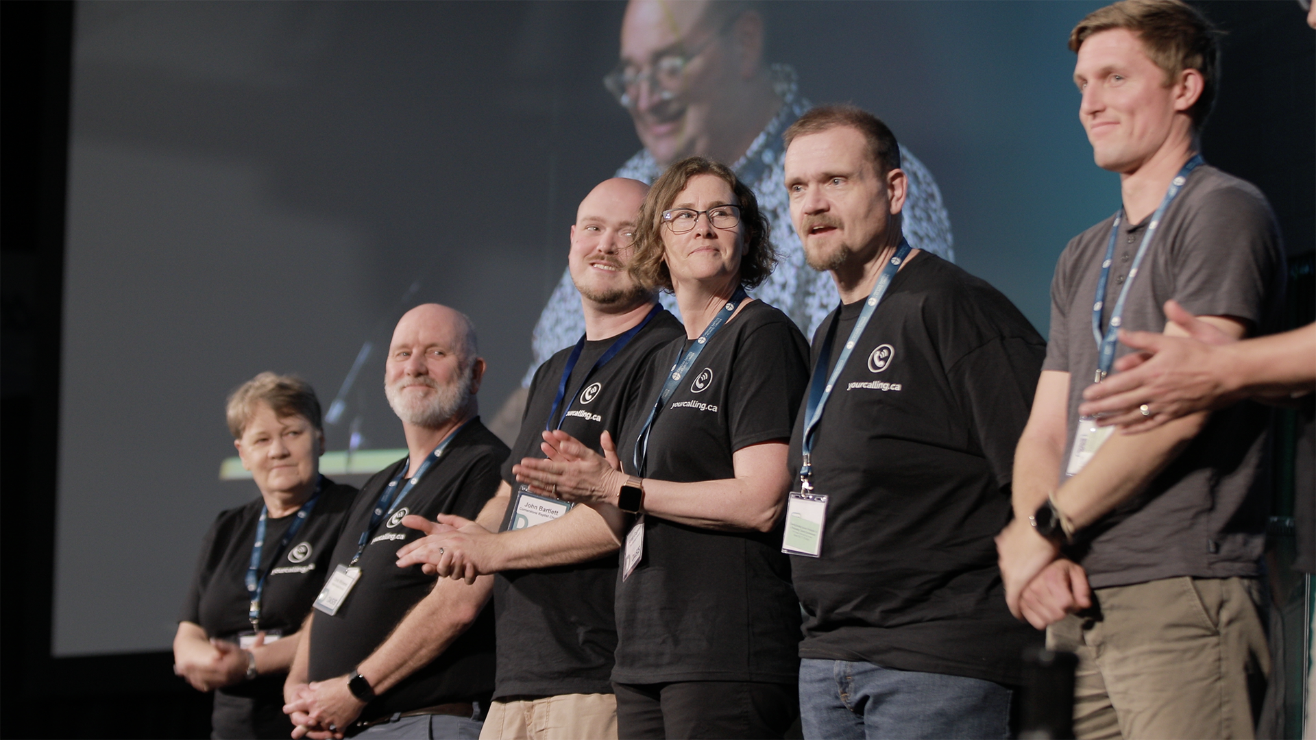 a group of men standing next to each other on a stage